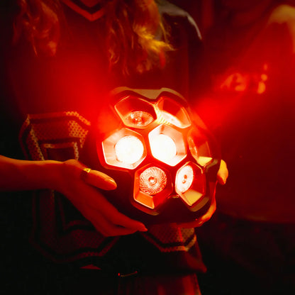Person holding a lightboks transmitting red light