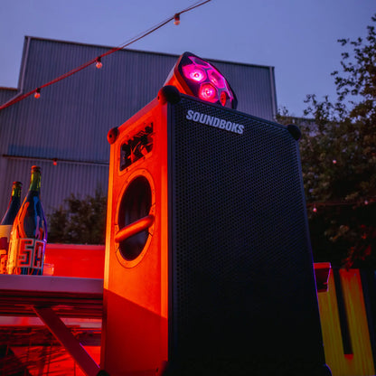 Black Soundboks 4 with red lighting on a outdoor setting